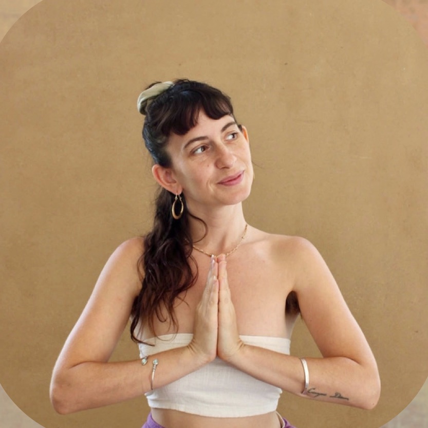 Yuli with palms pressed together, smiling